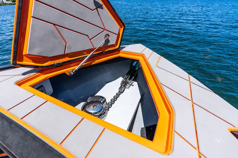 Slide: The Image of Open hatch of 2025 Statement 44 GRTS boat, revealing anchor storage by the water. - 29