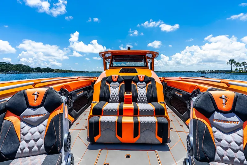 Slide: The Image of Luxurious 2025 Statement 44 GRTS boat interior with vibrant orange and black seating, on a sunny day. - 32