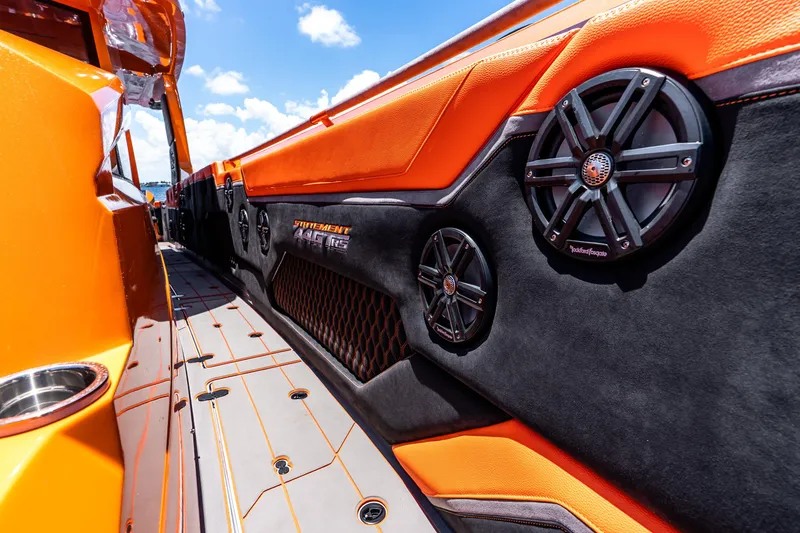 Slide: The Image of Orange and black interior of 2025 Statement 44 GRTS boat with premium speakers. - 35