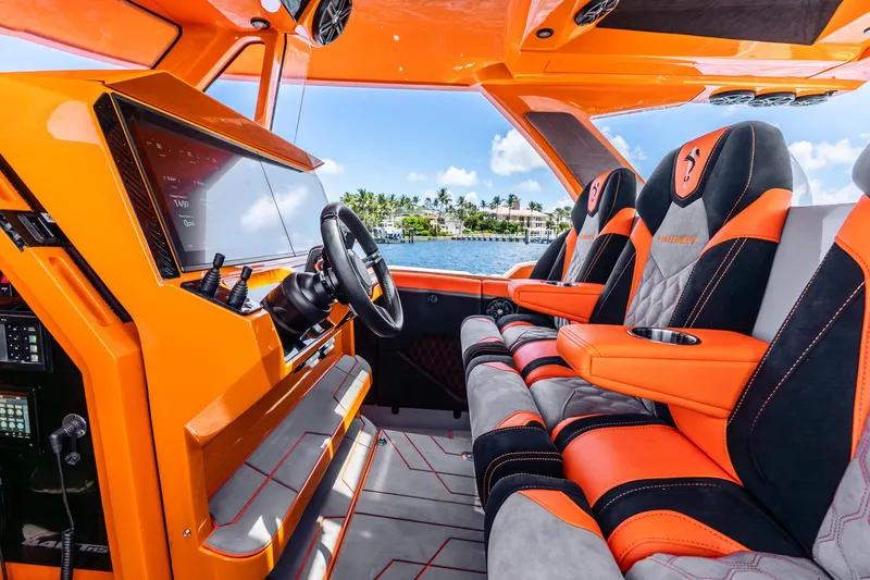 Slide: The Image of Interior of 2025 Statement 44 GRTS boat with vibrant orange and black seating. - 38