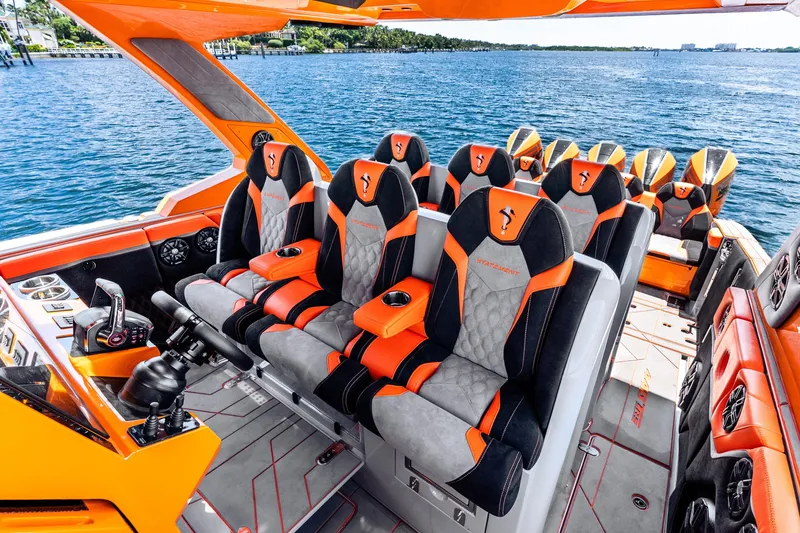 Slide: The Image of Luxurious 2025 Statement 44 GRTS boat interior with orange and black seating, overlooking the ocean. - 41