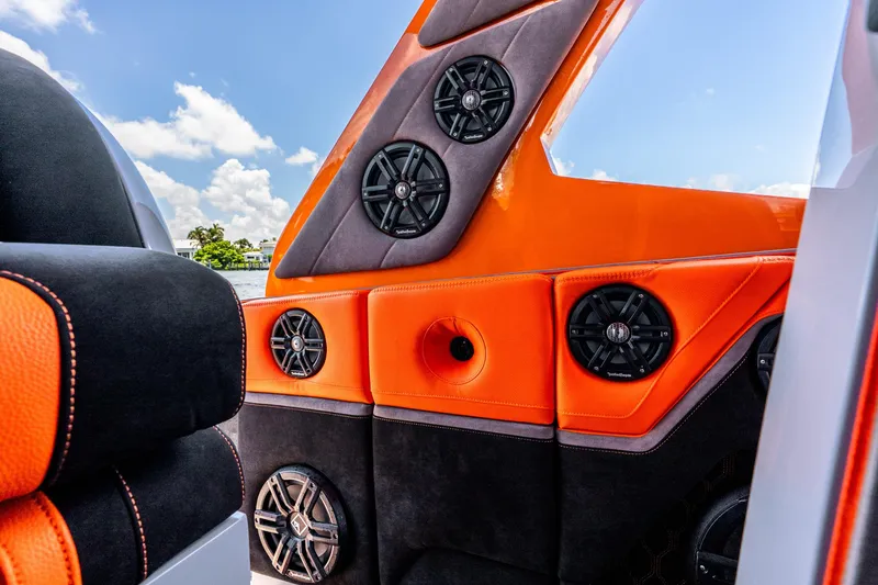 Slide: The Image of Orange and black interior of 2025 Statement 44 GRTS boat with multiple speakers. - 44