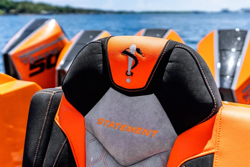 Slide: The Image of Orange and black seat on 2025 Statement 44 GRTS boat with water backdrop. - 45