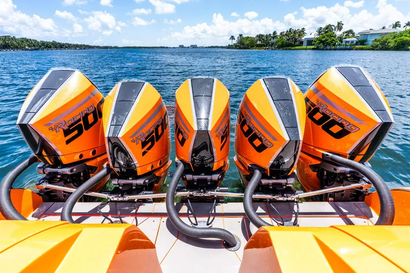 Slide: The Image of Four powerful orange outboard motors on a Statement 44 GRTS boat, 2025 model. - 49