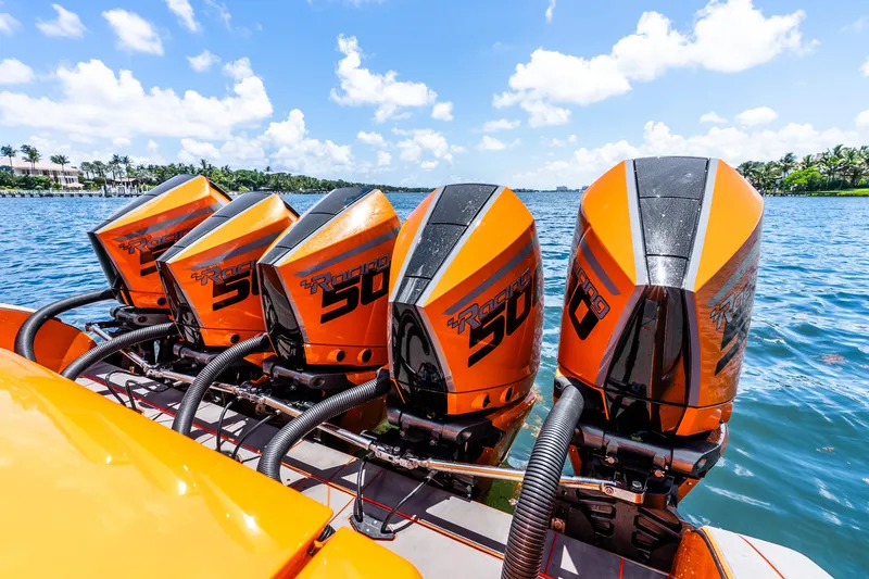 Slide: The Image of Four orange racing boat engines on a Statement 44 GRTS, 2025 model, on a sunny day. - 50