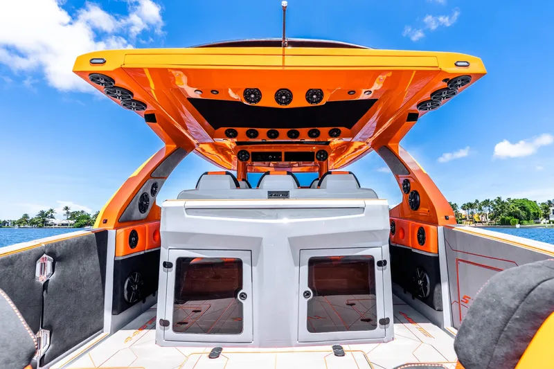 Slide: The Image of Luxury Statement 44 GRTS boat interior, vibrant orange design, 2025 model, on a sunny day. - 51