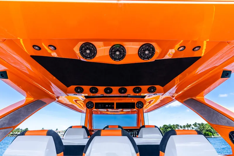 Slide: The Image of Orange interior of 2025 Statement 44 GRTS boat with speakers and seating. - 53