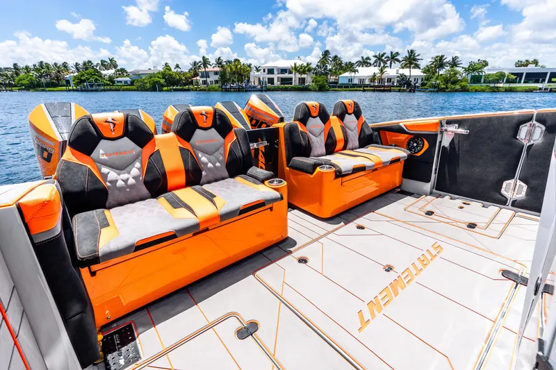 Slide: The Image of Luxury seating on 2025 Statement 44 GRTS boat, featuring vibrant orange and black design. - 54