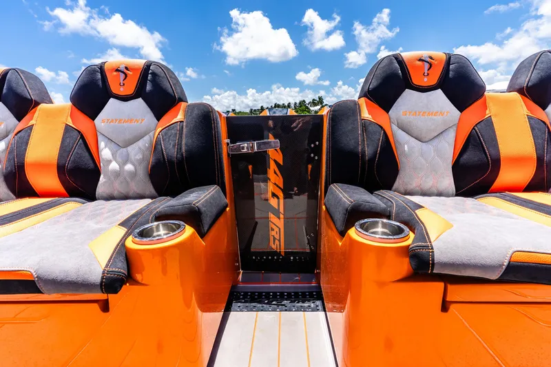 Slide: The Image of Luxury seating on 2025 Statement 44 GRTS boat, featuring orange and black design under blue sky. - 55