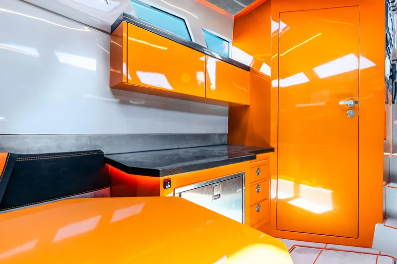 Slide: The Image of Modern interior of 2025 Statement 44 GRTS boat with vibrant orange cabinetry. - 64