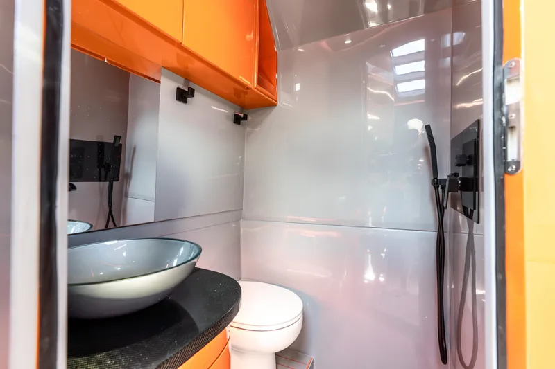 Slide: The Image of Modern bathroom in 2025 Statement 44 GRTS with sleek design and orange accents. - 65