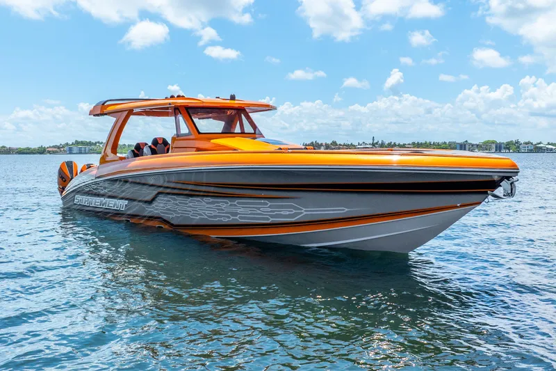 Slide: The Image of Orange and gray 2025 Statement 44 GRTS boat on water under blue sky. - 7