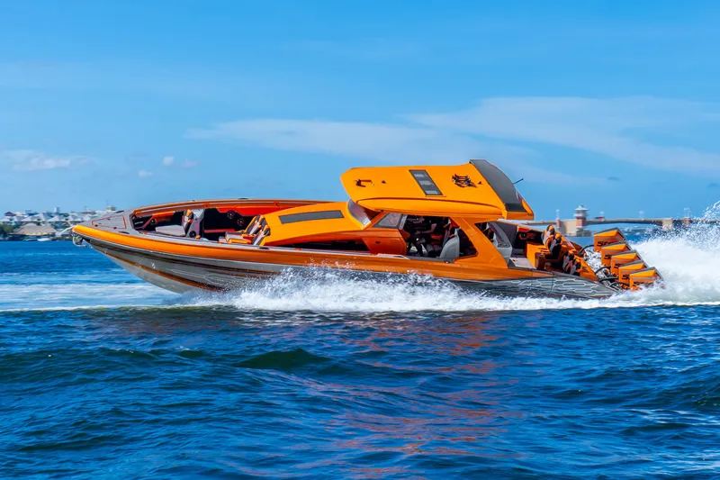 Slide: The Image of 2025 Statement 44 GRTS speedboat in vibrant orange, cruising swiftly on blue waters. - 73