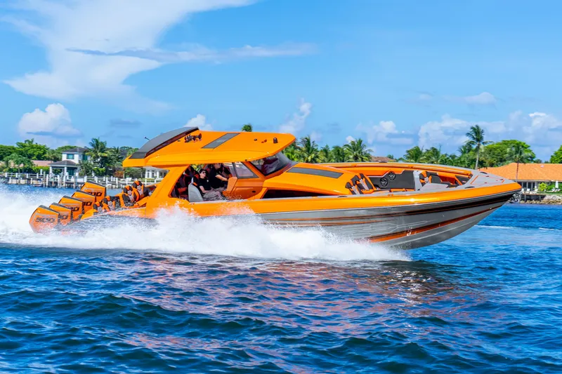 Slide: The Image of 2025 Statement 44 GRTS speedboat cruising on water, vibrant orange design, clear blue sky. - 74