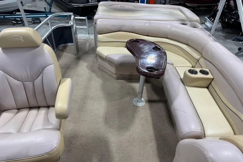 Slide: The Image of 2008 Bennington 2575 RL boat interior with plush seating and table. - 10