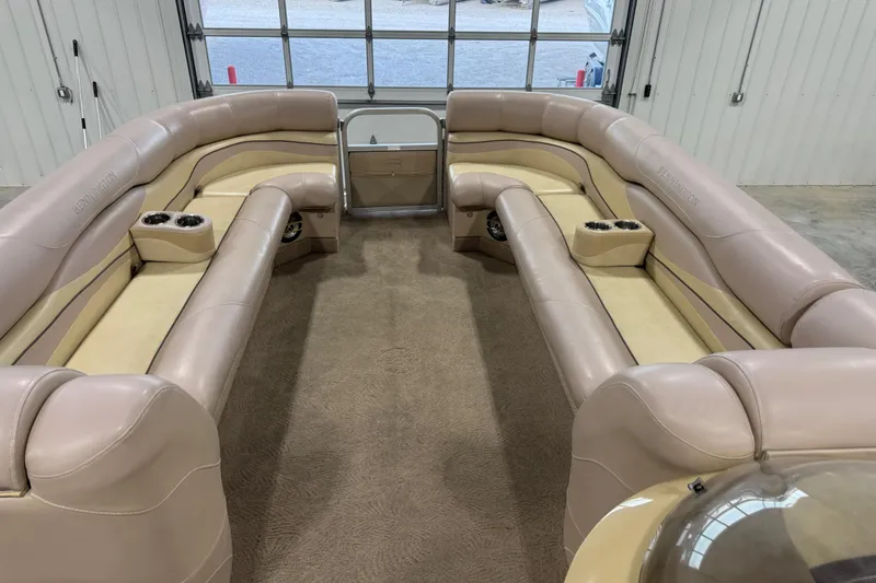 Slide: The Image of 2008 Bennington 2575 RL pontoon boat interior with beige seating and cup holders. - 11