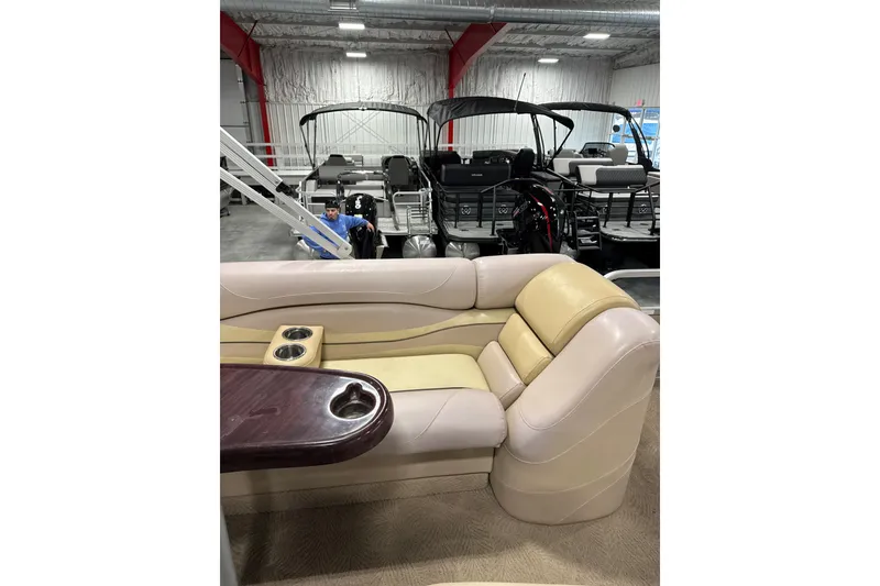 Slide: The Image of 2008 Bennington 2575 RL pontoon boat interior with beige seating and cup holders. - 13