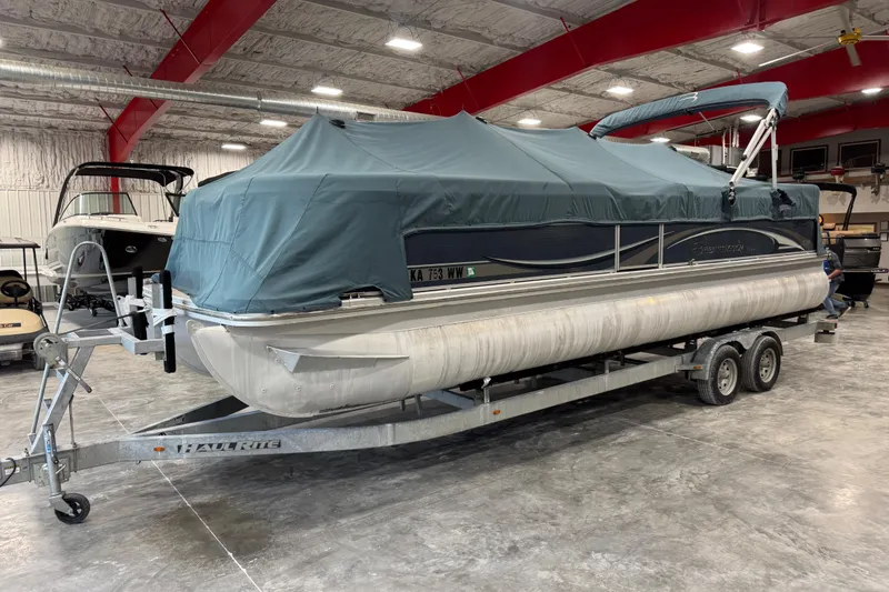 Slide: The Image of 2008 Bennington 2575 RL pontoon boat on trailer, covered, in indoor storage facility. - 6