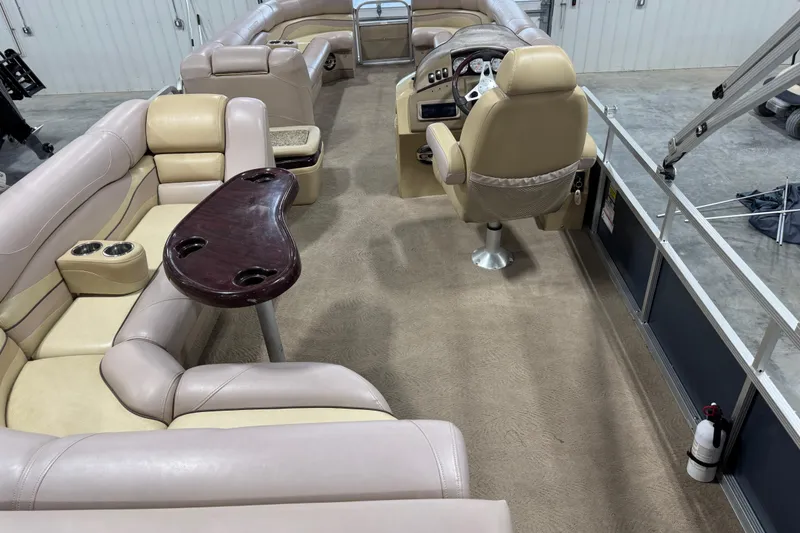 Slide: The Image of 2008 Bennington 2575 RL pontoon boat interior with beige seating and steering console. - 9