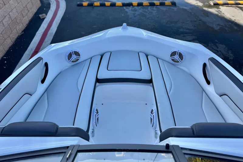Slide: The Image of 2019 Yamaha Boats SX190 interior with white seating and built-in speakers. - 11