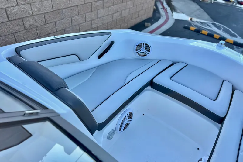 Slide: The Image of 2019 Yamaha Boats SX190 interior with white seating and built-in speakers. - 12