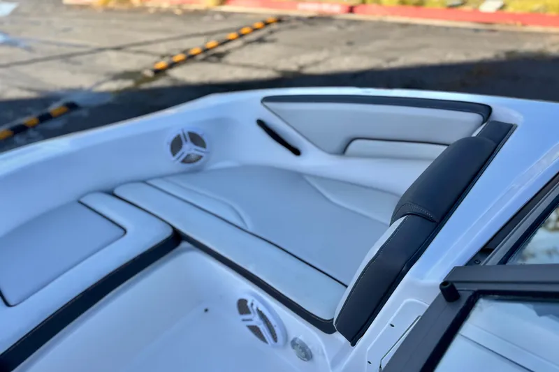 Slide: The Image of 2019 Yamaha Boats SX190 interior seating with sleek white and black design. - 13
