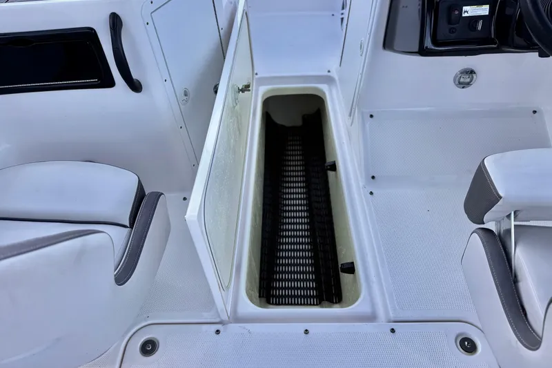 Slide: The Image of 2019 Yamaha Boats SX190 interior storage compartment with open hatch. - 18