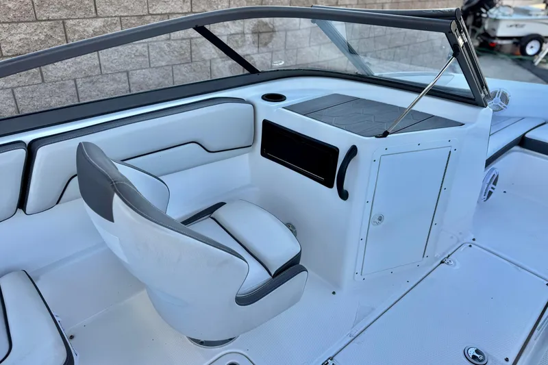 Slide: The Image of 2019 Yamaha Boats SX190 interior with white seating and dashboard, showcasing modern design. - 19