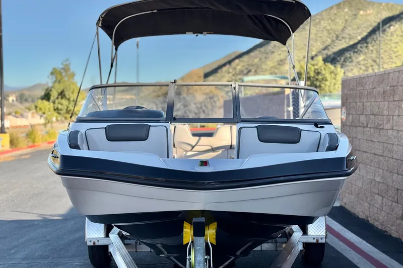 Slide: The Image of 2019 Yamaha Boats SX190 on trailer, parked outdoors with scenic mountain backdrop. - 2