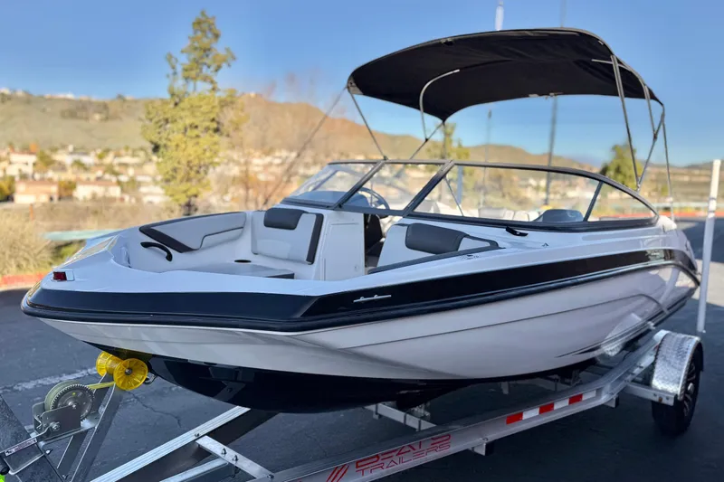 Slide: The Image of 2019 Yamaha Boats SX190 on trailer, featuring sleek design and black canopy. - 3