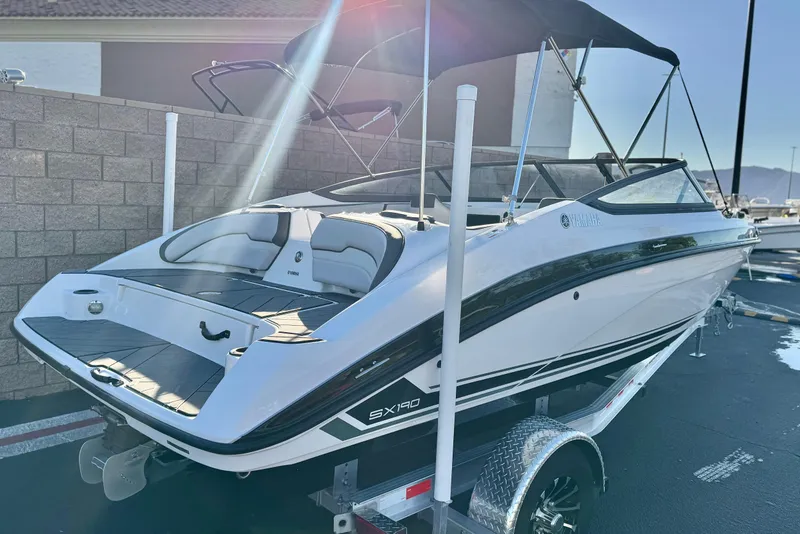 Slide: The Image of 2019 Yamaha Boats SX190 on trailer, sleek design, black and white color scheme. - 5
