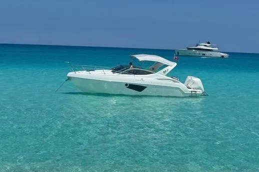 The Image of 2023 Schaefer 303 Sport boat on clear turquoise water, with another yacht in the background. - 1