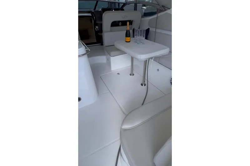 Slide: The Image of Interior of 2023 Schaefer 303 Sport yacht with table, champagne, and glasses. - 10