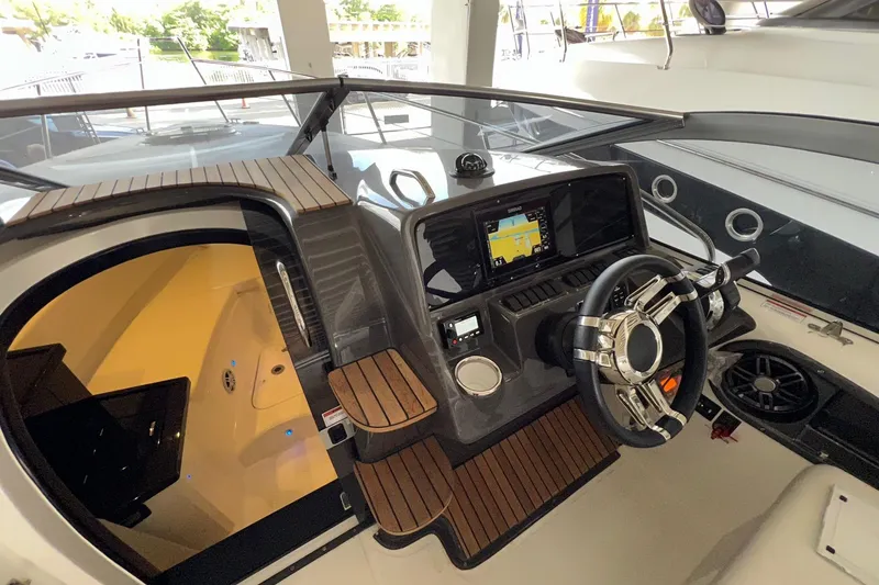 Slide: The Image of 2023 Schaefer 303 Sport boat cockpit with modern steering and navigation system. - 3