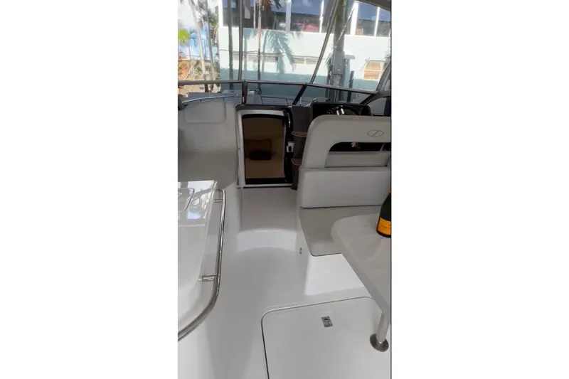 Slide: The Image of 2023 Schaefer 303 Sport boat interior with seating and table, featuring modern design. - 5