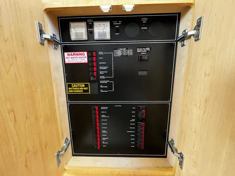 Slide: The Image of Electrical panel inside 1996 Carver 325 Aft Cabin boat, featuring switches and warning labels. - 36