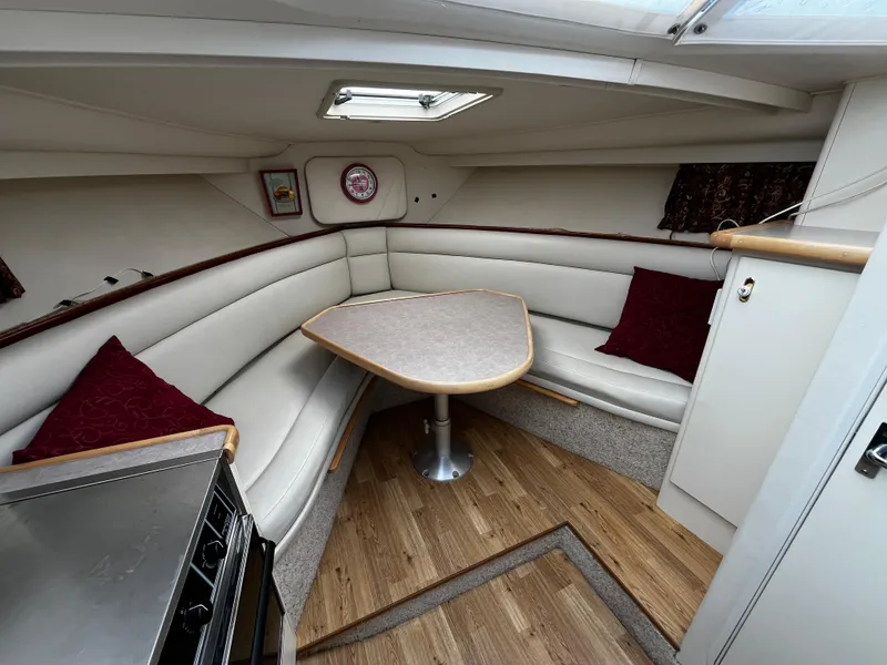 Slide: The Image of 1996 Carver 325 Aft Cabin bedroom with patterned bedding and wooden cabinetry. - 29