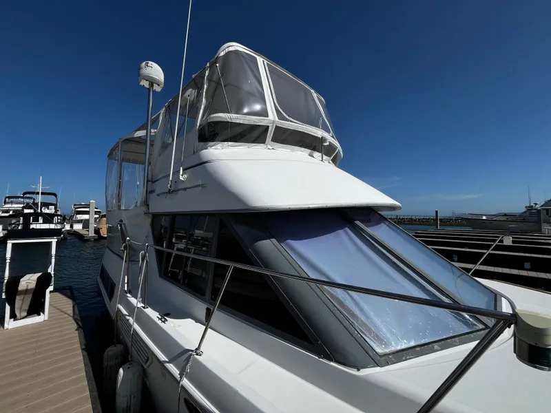 Slide: The Image of 1996 Carver 325 Aft Cabin yacht with clear canopy under blue sky. - 6