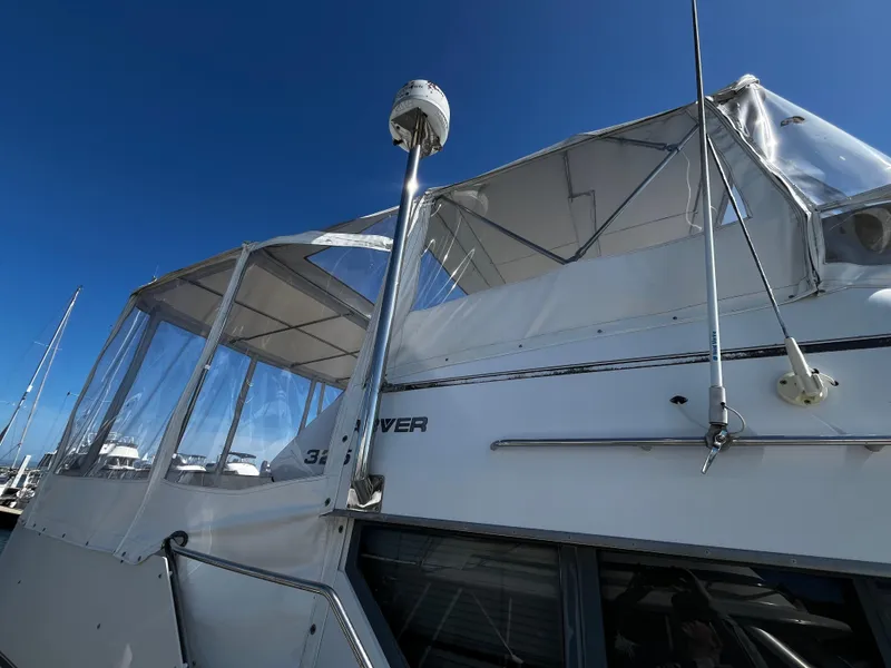 Slide: The Image of 1996 Carver 325 Aft Cabin yacht docked at marina under clear blue sky. - 7
