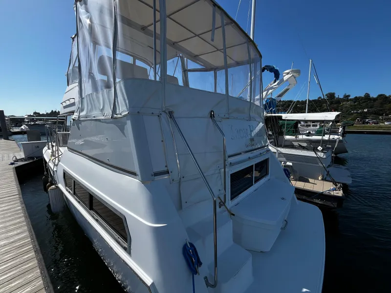Slide: The Image of 1996 Carver 325 Aft Cabin yacht docked at marina under clear blue sky. - 8