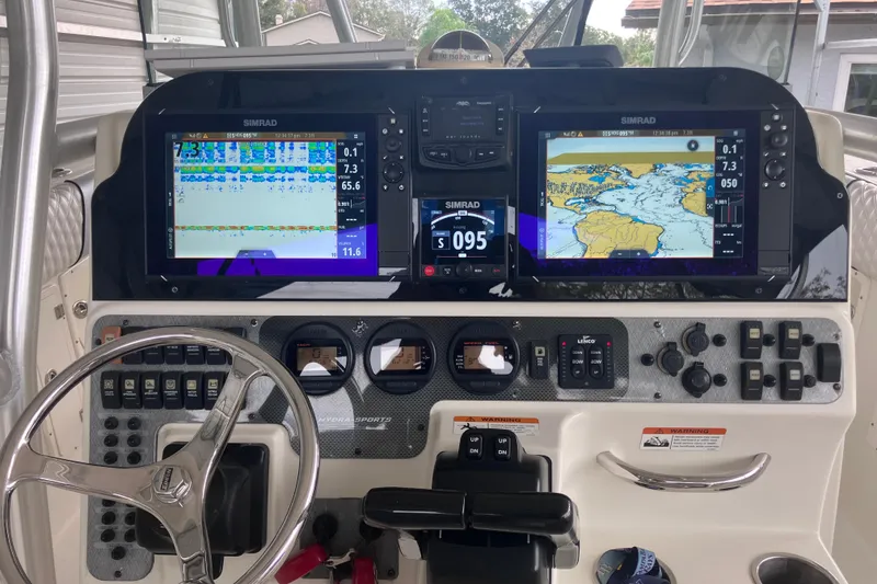 Slide: The Image of 2008 Hydra-Sports Vector 2900 CC dashboard with Simrad navigation displays and controls. - 28