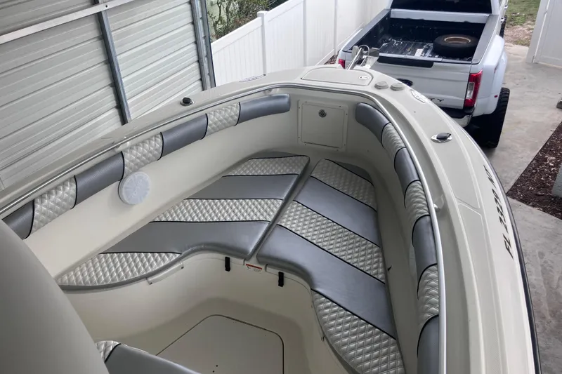 Slide: The Image of 2008 Hydra-Sports Vector 2900 CC boat interior with cushioned seating in a garage. - 32