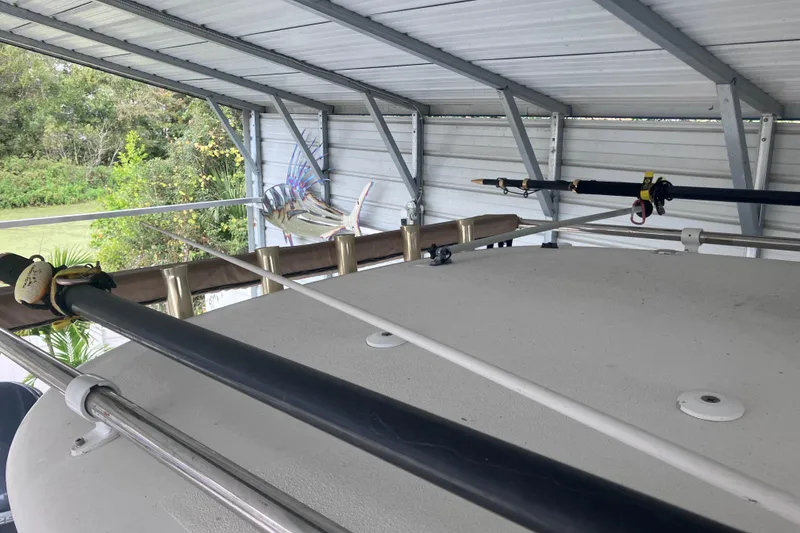 Slide: The Image of 2008 Hydra-Sports Vector 2900 CC boat under metal shelter with fishing rods. - 62