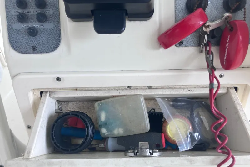 Slide: The Image of 2008 Hydra-Sports Vector 2900 CC console storage with keys and boating accessories. - 65