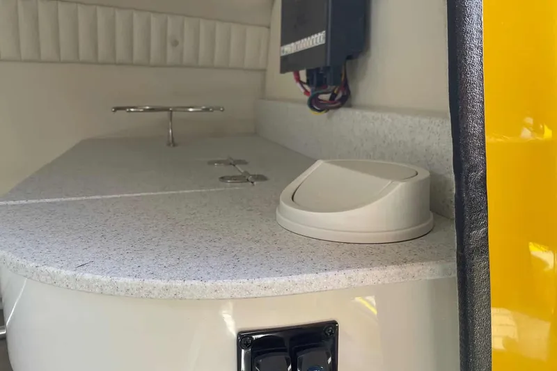 Slide: The Image of Stingray 23 OCX 2025 boat drive on gravel surface. - 13