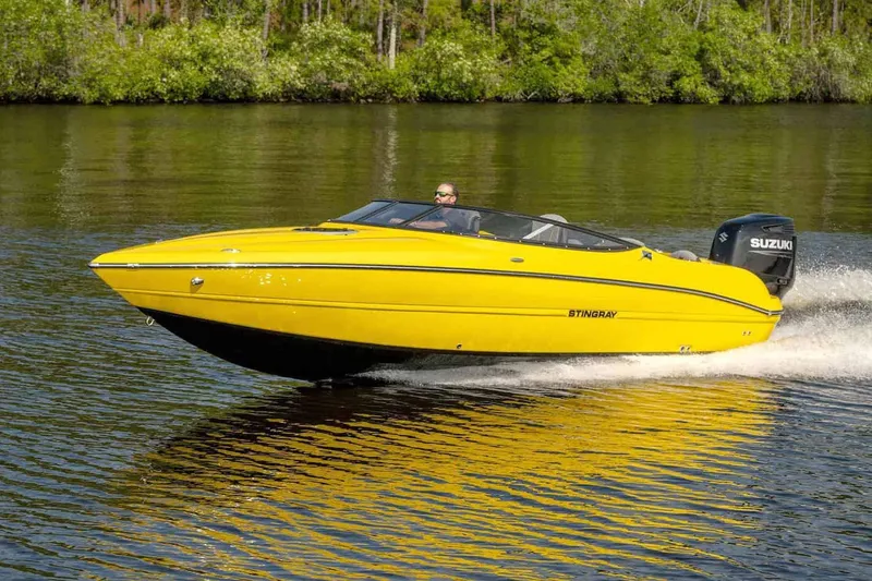 Slide: The Image of Stingray 23 OCX 2025 boat with American flag and water connection. - 19