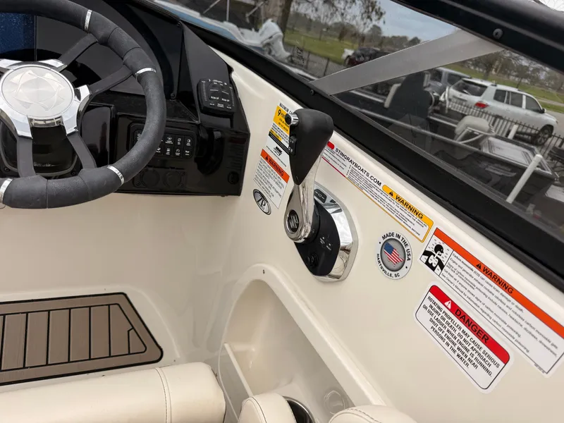 Slide: The Image of Interior view of a Stingray 23 OCX boat's helm, model year 2025. - 24