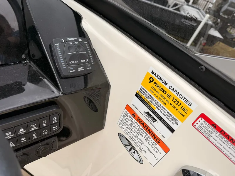 Slide: The Image of Stingray 23 OCX 2025 boat console with capacity warning. - 25