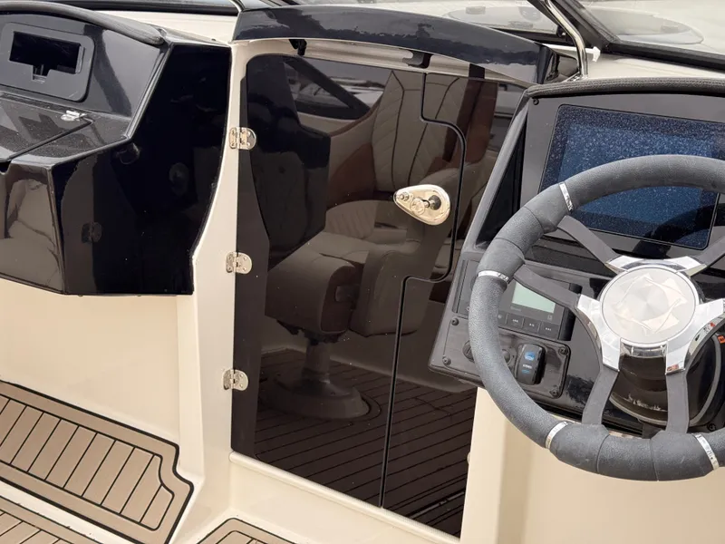 Slide: The Image of Interior of 2025 Stingray 23 OCX with steering wheel and dashboard. - 28