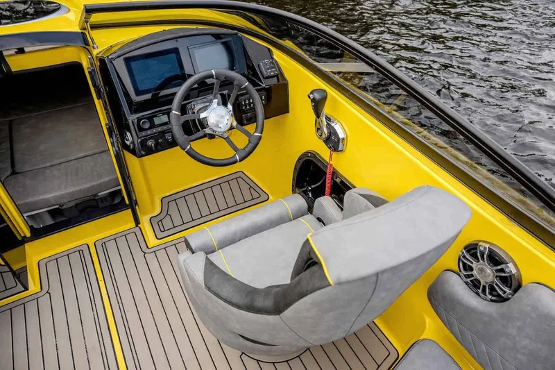 Slide: The Image of 2025 Stingray 23 OCX boat on trailer under cloudy sky. - 7